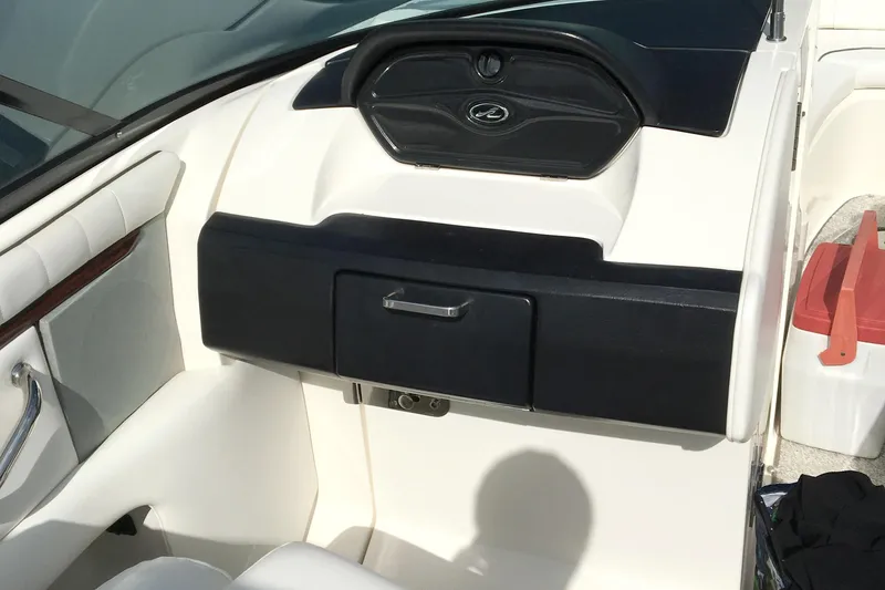 Slide: The Image of 2008 Sea Ray 270 SLX boat interior dashboard with storage compartment. - 13