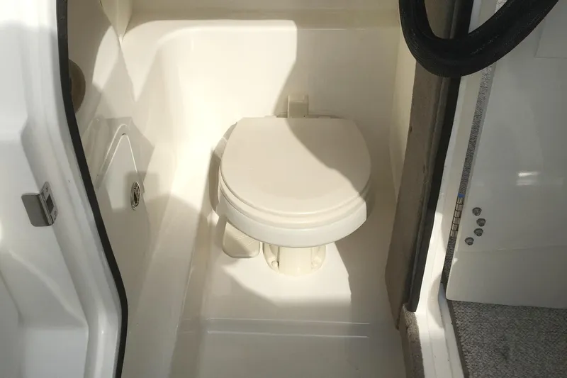 Slide: The Image of 2008 Sea Ray 270 SLX boat interior with compact marine toilet. - 14