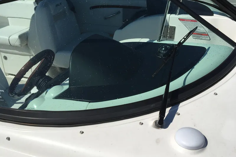 Slide: The Image of Interior view of a 2008 Sea Ray 270 SLX boat, featuring steering wheel and dashboard. - 7