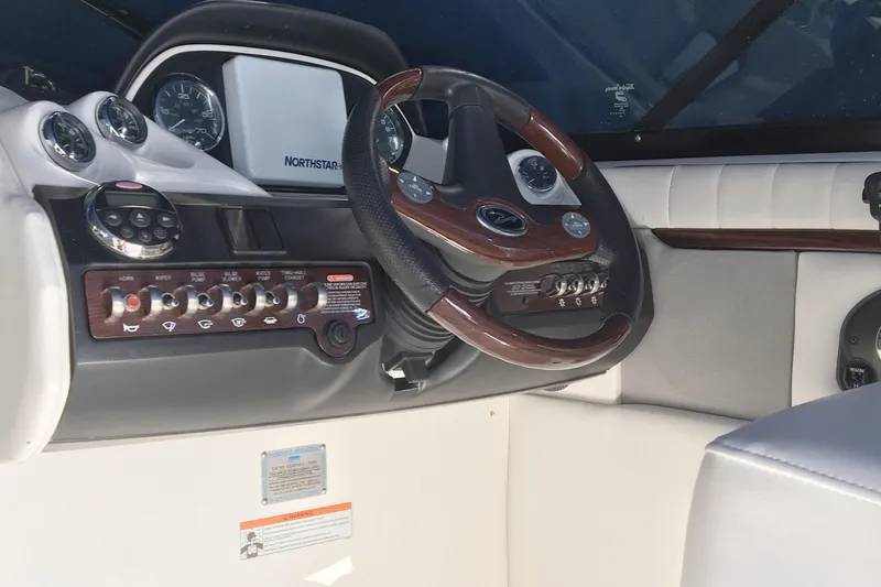 Slide: The Image of 2008 Sea Ray 270 SLX boat dashboard with steering wheel and control panel. - 8