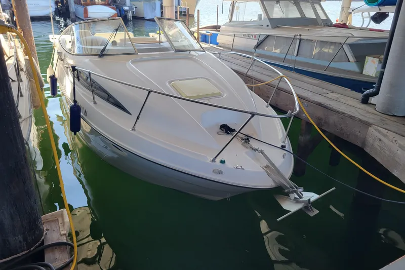 The Image of 2001 Bayliner 2655 Ciera docked in a marina, surrounded by water and other boats. - 0