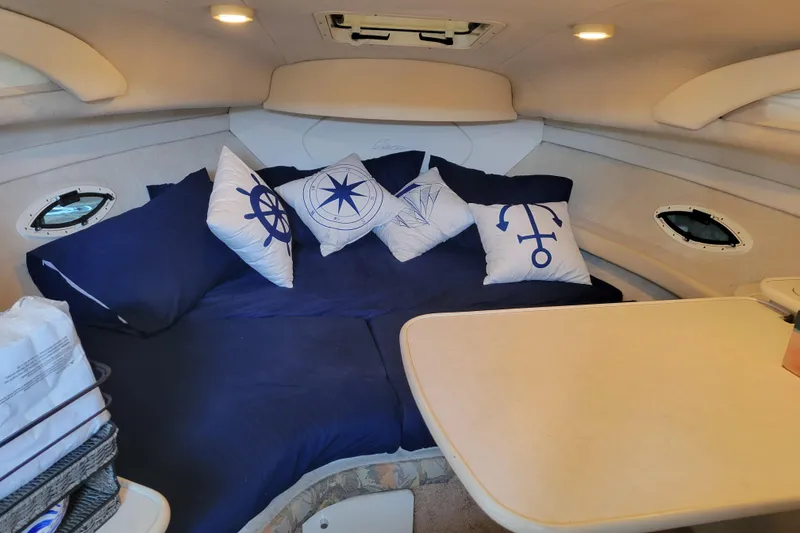 Slide: The Image of Cozy interior of 2001 Bayliner 2655 Ciera with nautical-themed pillows and table. - 14