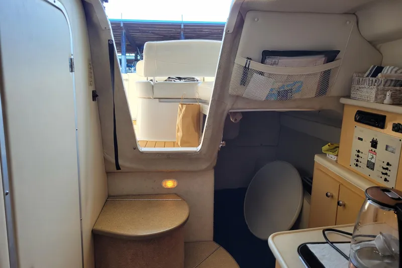 Slide: The Image of Interior of 2001 Bayliner 2655 Ciera boat, featuring cabin and control panel. - 16