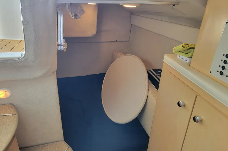 Slide: The Image of Interior cabin of 2001 Bayliner 2655 Ciera boat, featuring seating and storage. - 17