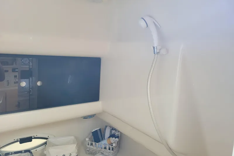 Slide: The Image of Interior of 2001 Bayliner 2655 Ciera boat bathroom with showerhead and storage. - 20