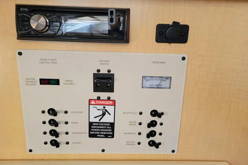 Slide: The Image of 2001 Bayliner 2655 Ciera shore power control panel with stereo system and voltage meter. - 21