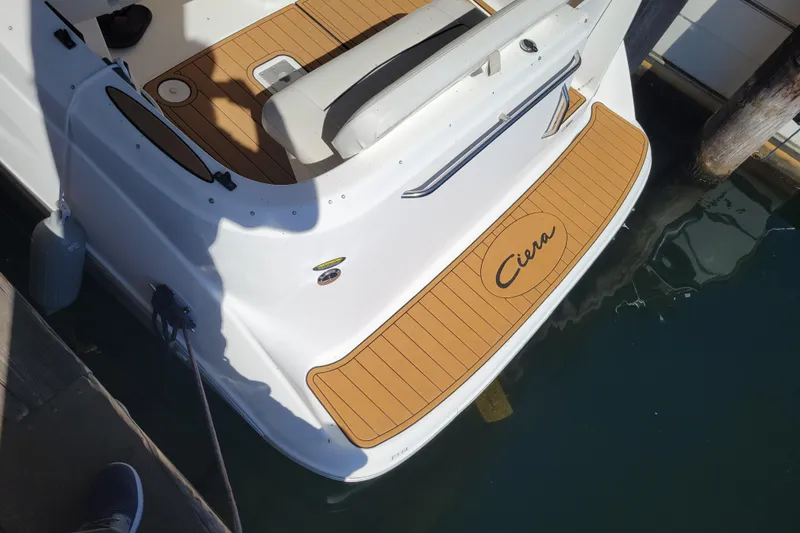 Slide: The Image of 2001 Bayliner 2655 Ciera boat docked, featuring teak-style swim platform. - 3