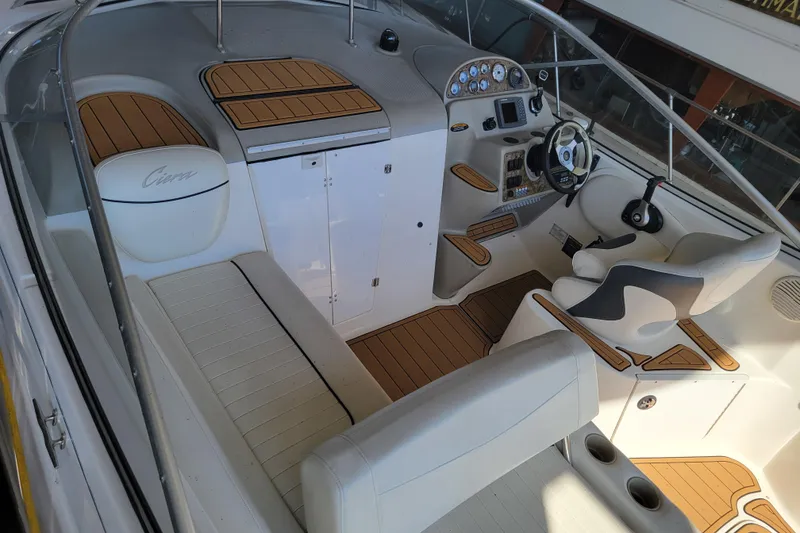 Slide: The Image of 2001 Bayliner 2655 Ciera boat interior with seating, steering wheel, and control panel. - 5
