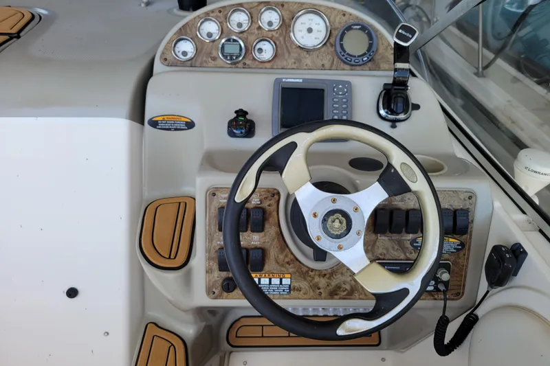 Slide: The Image of 2001 Bayliner 2655 Ciera boat dashboard with steering wheel and control panel. - 7