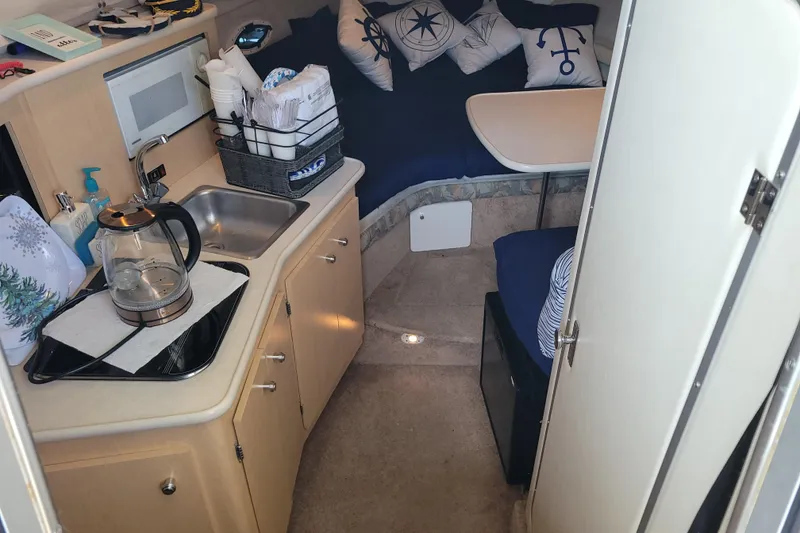 Slide: The Image of 2001 Bayliner 2655 Ciera cabin interior with kitchenette and seating area. - 9
