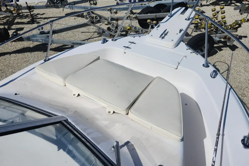 Slide: The Image of 2000 Grady-White Adventure 208 boat deck with cushioned seating and railings. - 10