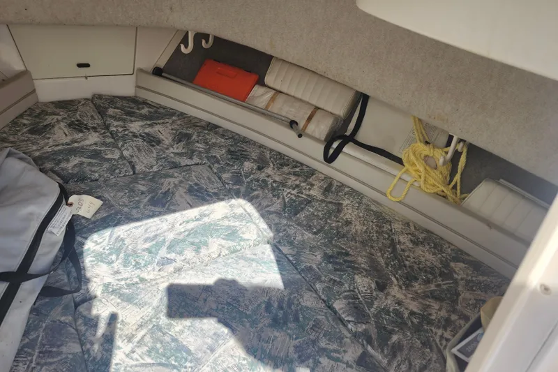 Slide: The Image of Interior cabin of 2000 Grady-White Adventure 208 boat with patterned cushions and storage. - 11