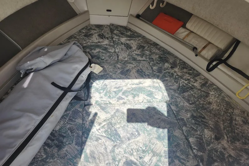 Slide: The Image of Interior of 2000 Grady-White Adventure 208 boat cabin with storage and seating. - 12