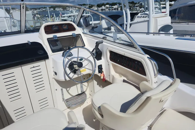 Slide: The Image of 2000 Grady-White Adventure 208 boat cockpit with steering wheel and control panel. - 3