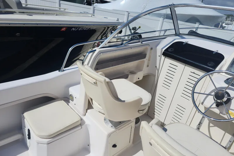 Slide: The Image of Interior of 2000 Grady-White Adventure 208 boat with steering wheel and seating. - 4