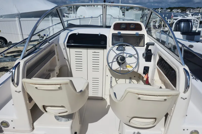 Slide: The Image of 2000 Grady-White Adventure 208 boat cockpit with steering wheel and dual seats. - 6