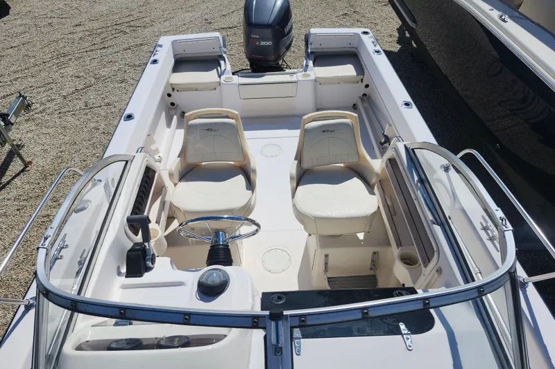 Slide: The Image of 2000 Grady-White Adventure 208 boat interior with seating and steering wheel. - 7