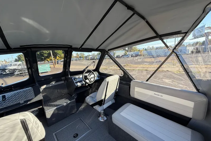 Slide: The Image of 2026 Thunder Jet 200 Luxor boat interior with steering wheel and seating. - 18