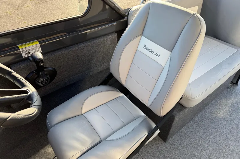 Slide: The Image of 2026 Thunder Jet 200 Luxor boat interior with gray seating and steering wheel. - 22