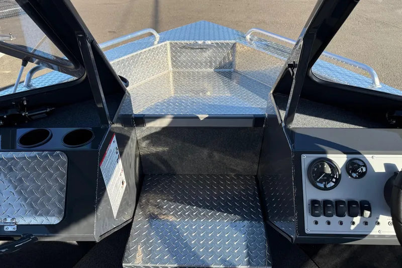 Slide: The Image of 2026 Thunder Jet 200 Luxor boat interior with diamond plate flooring and control panel. - 24