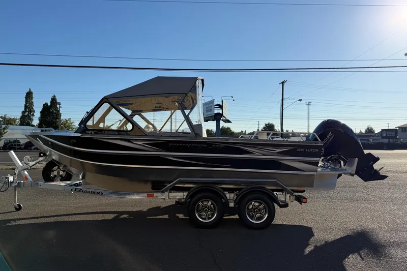 Slide: The Image of 2026 Thunder Jet 200 Luxor boat on trailer, parked outdoors under clear sky. - 4