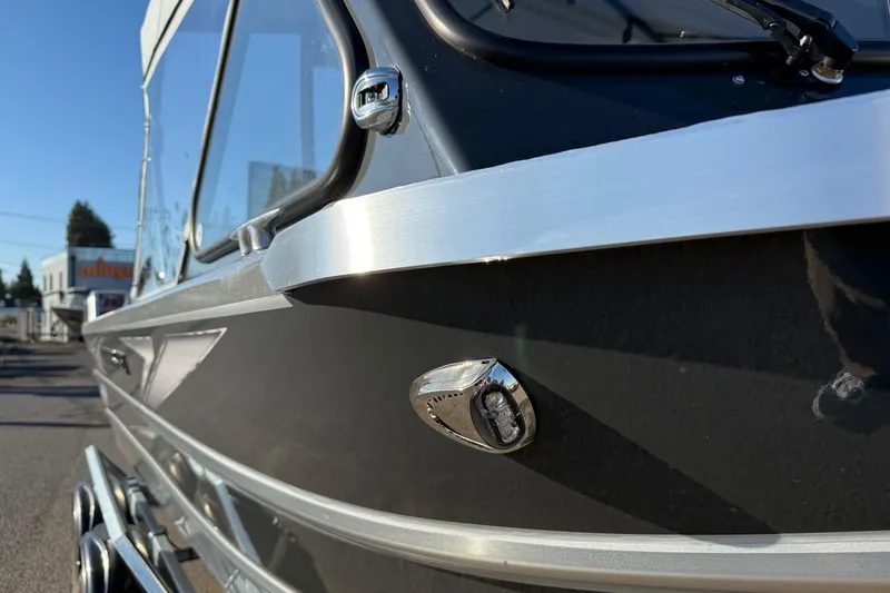 Slide: The Image of 2026 Thunder Jet 200 Luxor boat, sleek black exterior with chrome detailing. - 7