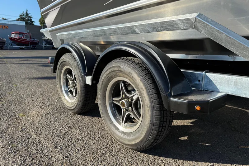 Slide: The Image of Trailer wheels of a 2026 Thunder Jet 200 Luxor boat on asphalt surface. - 8