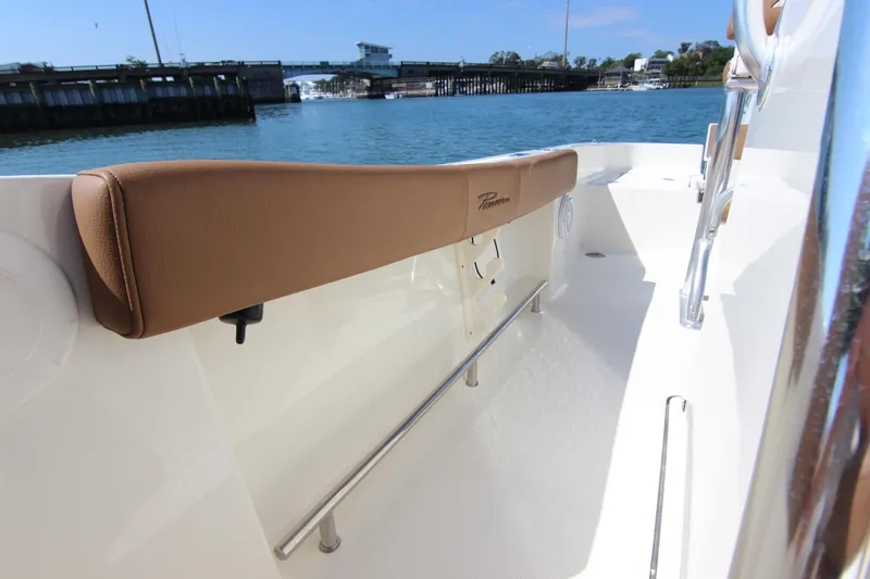 Slide: The Image of 2022 Pioneer 220 Bay Sport boat interior with tan seating and stainless steel railing. - 13