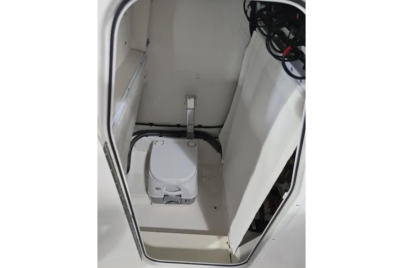 Slide: The Image of 2026 Sea Born LX24 Center Console boat interior with compact marine toilet. - 17