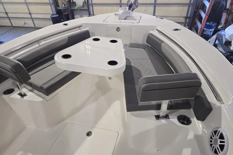 Slide: The Image of 2026 Sea Born LX24 Center Console boat interior with seating and table setup. - 20