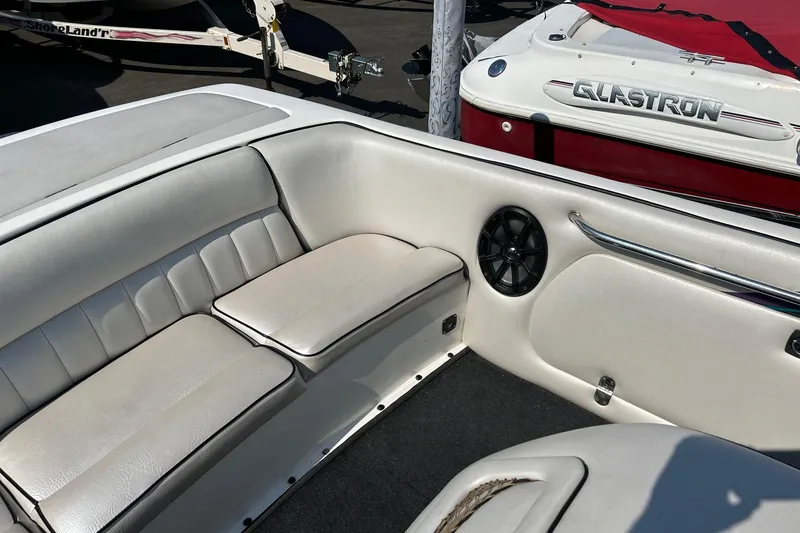 Slide: The Image of Interior of a 1998 MB Boss 210 boat with white seating and speaker. - 10