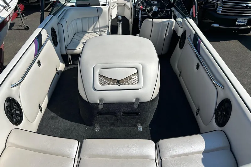 Slide: The Image of Interior of a 1998 MB Boss 210 boat with white seating and dashboard. - 13