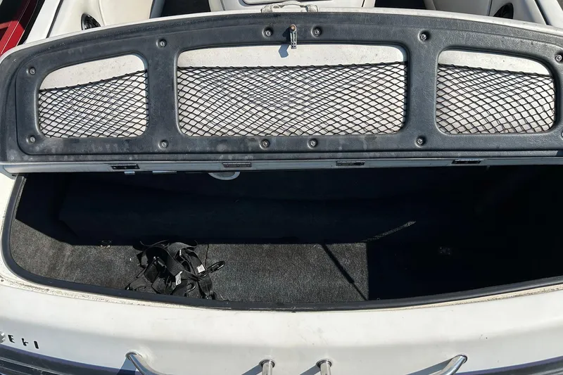 Slide: The Image of Open storage compartment of 1998 MB Boss 210 boat with netted cover. - 15