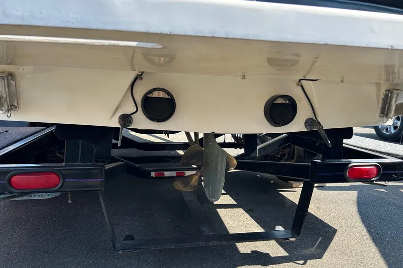 Slide: The Image of Rear view of 1998 MB Boss 210 boat on trailer, showing propeller and exhaust ports. - 17