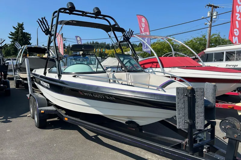 Slide: The Image of 1998 MB Boss 210 boat on trailer, displayed outdoors at a dealership. - 3