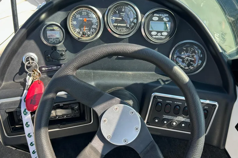 Slide: The Image of Dashboard of a 1998 MB Boss 210 boat with gauges and controls. - 4
