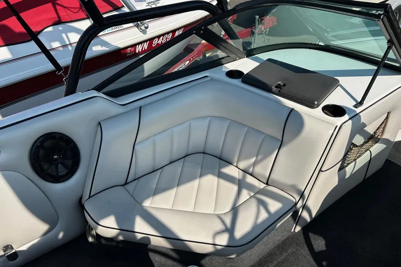 Slide: The Image of Interior of a 1998 MB Boss 210 boat with white seating and speaker. - 9