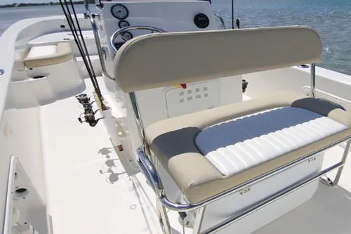Slide: The Image of Interior seating of 2026 Sundance DX22 boat with gray cushions. - 12
