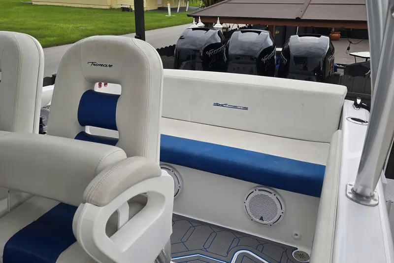 Slide: The Image of 2016 Extreme Boats 38 Cuddy Cabin with T-top and seating, parked on grass. - 11