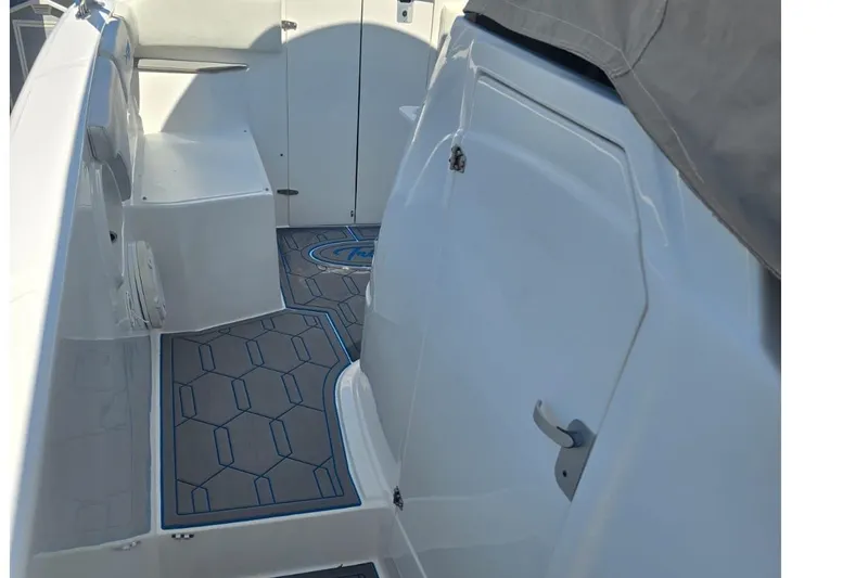 Slide: The Image of 2016 Extreme Boats 38 Cuddy Cabin bathroom with toilet, shower, and storage shelf. - 24