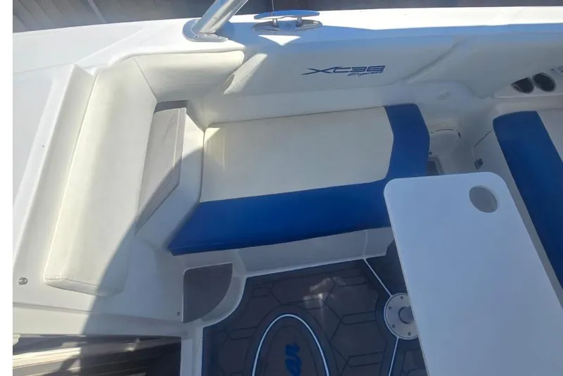 Slide: The Image of 2016 Extreme Boats 38 Cuddy Cabin interior with seating and windshield, parked on grass. - 33