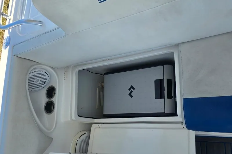 Slide: The Image of 2016 Extreme Boats 38 Cuddy Cabin interior with seating and table, parked outdoors. - 34