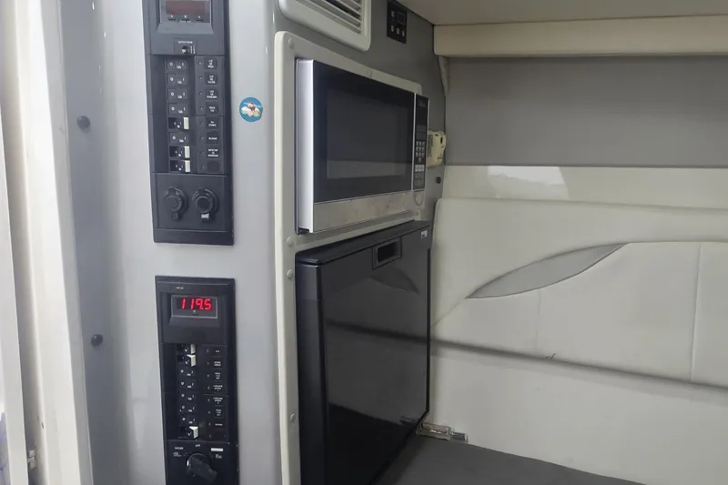 Slide: The Image of Control panel inside 2016 Extreme Boats 38 Cuddy Cabin, featuring various switches and settings. - 44