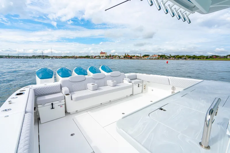 Slide: The Image of 2026 HCB 56 Suenos GIX luxury boat with spacious deck and seating on calm waters. - 10