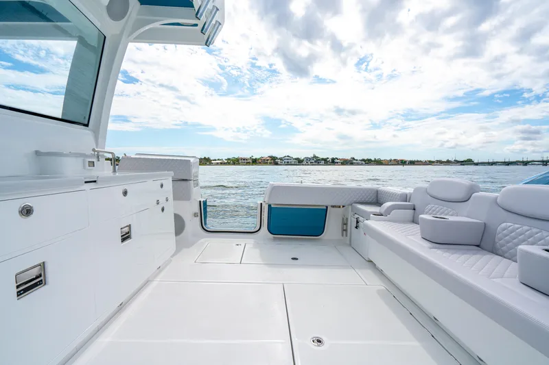 Slide: The Image of Luxurious interior of 2026 HCB 56 Suenos GIX yacht with plush seating and ocean view. - 13