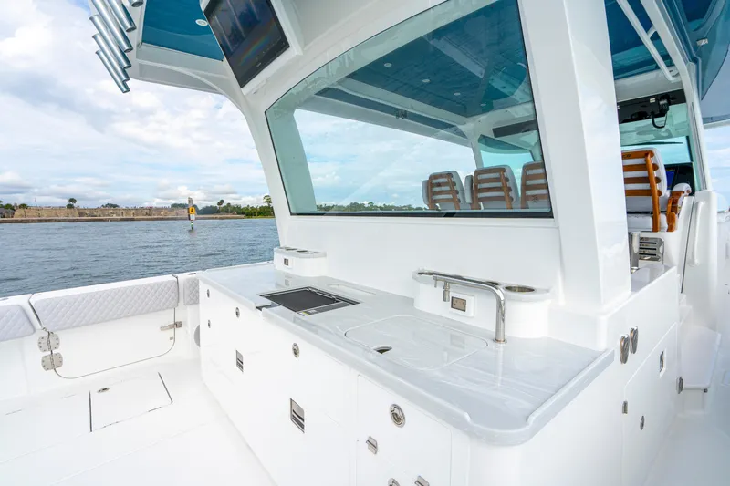 Slide: The Image of 2026 HCB 56 Suenos GIX yacht interior with sleek kitchen and seating area. - 16