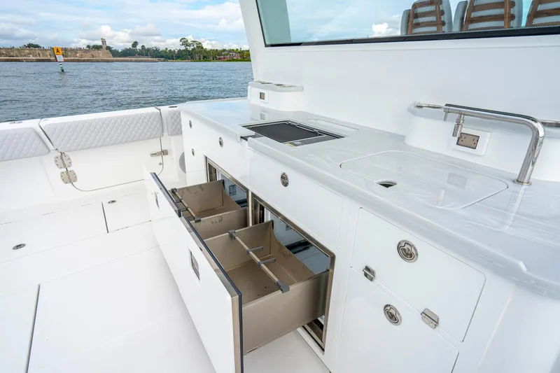Slide: The Image of Luxurious 2026 HCB 56 Suenos GIX yacht kitchen with sleek white cabinetry and modern amenities. - 18