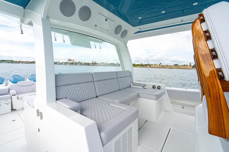 Slide: The Image of Luxurious interior of 2026 HCB 56 Suenos GIX yacht with plush seating and scenic water view. - 23