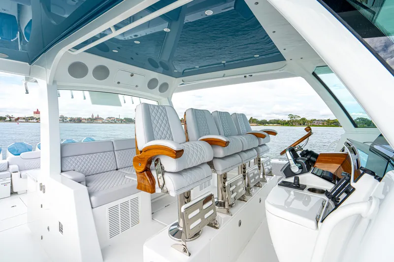 Slide: The Image of Luxurious interior of 2026 HCB 56 Suenos GIX yacht with plush seating and modern helm. - 25
