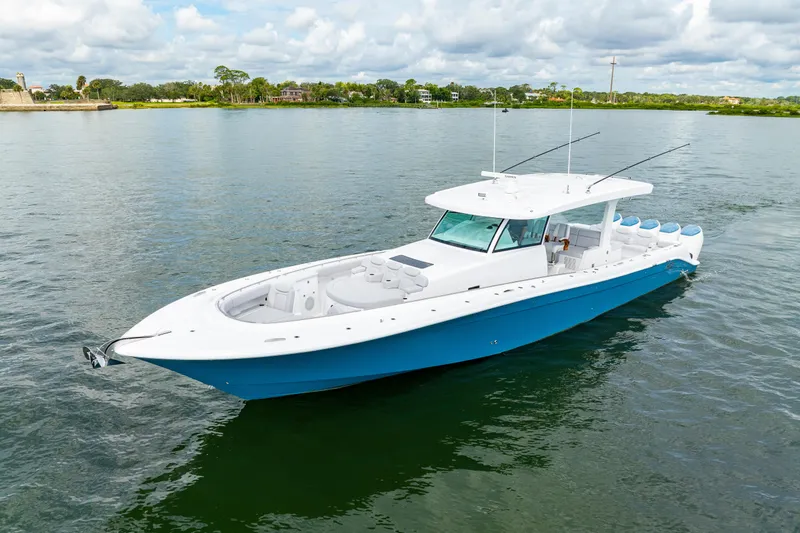 Slide: The Image of 2026 HCB 56 Suenos GIX luxury boat on calm water, featuring sleek design and spacious deck. - 3